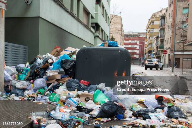 Piles of garbage bags next to a dumpster, on 10 January, 2022 in Salt, Girona, Catalonia, Spain. The garbage workers' strike in Salt has been going...