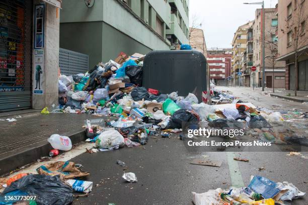 Piles of garbage bags next to a dumpster, on 10 January, 2022 in Salt, Girona, Catalonia, Spain. The garbage workers' strike in Salt has been going...