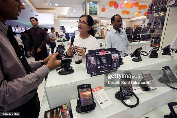 Customers look at blackberry phones in Vijay Electronics Sales on September 18, 2010 in Mumbai, India. In the name of national security, India is...