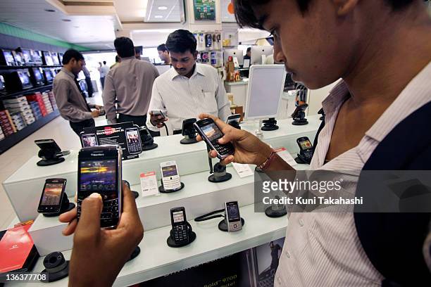 Customers look at blackberry phones in Vijay Electronics Sales on September 18, 2010 in Mumbai, India. In the name of national security, India is...