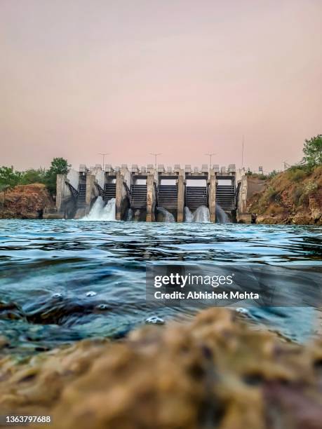 view of dam low angle - wasserkraft stock-fotos und bilder