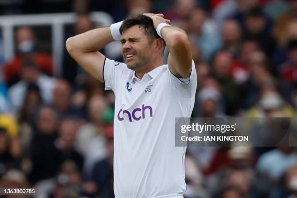 England's James Anderson reacts after Australia's Steven Smith edges a shot through the England fielders on day three of the second Ashes cricket...