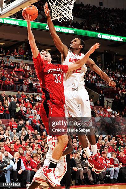 Sam Thompson of the Ohio State Buckeyes moves in to block a shot attempt by Mike Fox of the Nebraska Cornhuskers in the second half on January 3,...