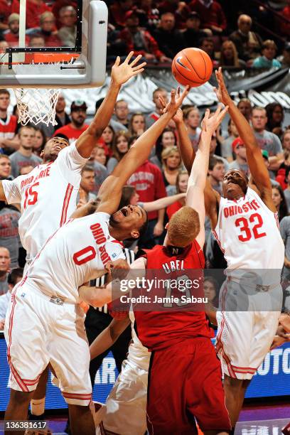 Weatherspoon, Jared Sullinger and Lenzelle Smith, Jr. #32, all of the Ohio State Buckeyes, gang up to take control of a rebound from Brandon Ubel of...