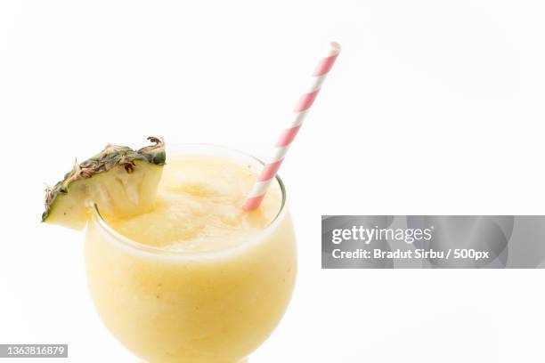 pineapple smoothie,close-up of drink against white background - pina colada stock-fotos und bilder