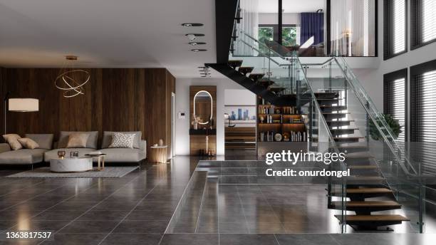 luxury modern house interior with corner sofa, bookshelf and staircase - tiled floor imagens e fotografias de stock