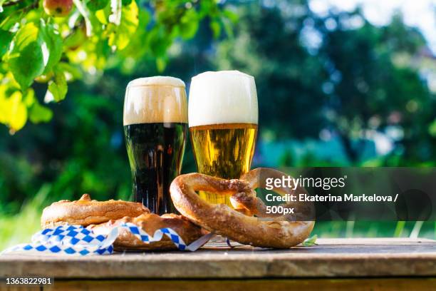 beer and pretzels,beer fest party,close-up of beer with pretzel on table - wheat beer stock pictures, royalty-free photos & images