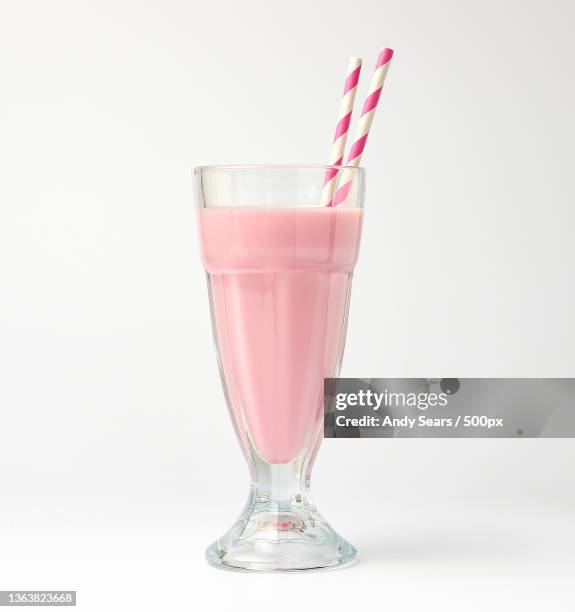 milkshake,close-up of pink drink in glass against white background,london,united kingdom,uk - smoothie stock pictures, royalty-free photos & images