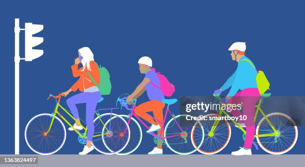 cyclists waiting at the lights - commuter stock illustrations