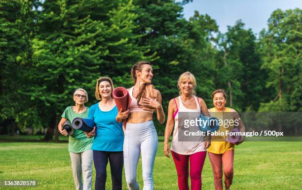 group of middle-aged and senior women training with fitness coach at park - mental toughness stock pictures, royalty-free photos & images