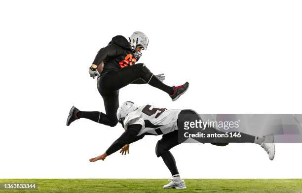 two american football players in action, motion. sportsmen fight for ball isolated on white background on grass - quarterback isolated stock pictures, royalty-free photos & images