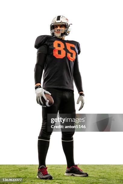 strong, muscled american football player wearing sports uniform posing isolated on white background. concept of sport, lifestyle. - american football player silhouette stock pictures, royalty-free photos & images