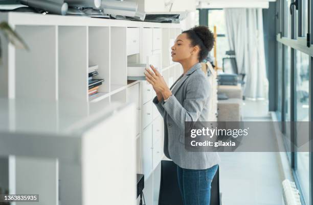 checking office inventory. - filing cabinet stock pictures, royalty-free photos & images