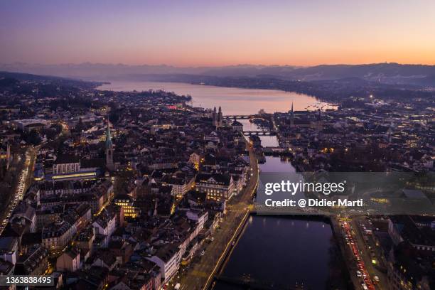 dramatic aerial view of the sunset over the zurich old town with the limmat river and lake zurich in the background in switzerland largest city - zurich switzerland stock pictures, royalty-free photos & images