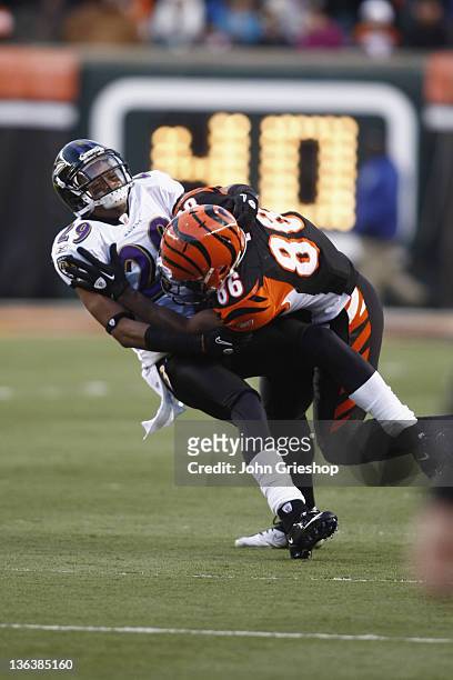 Donald Lee of the Cincinnati Bengals is tackled by Cary Williams of the Baltimore Ravens during their game at Paul Brown Stadium on January 1, 2012...