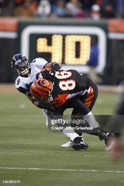 Donald Lee of the Cincinnati Bengals is tackled by Cary Williams of the Baltimore Ravens during their game at Paul Brown Stadium on January 1, 2012...