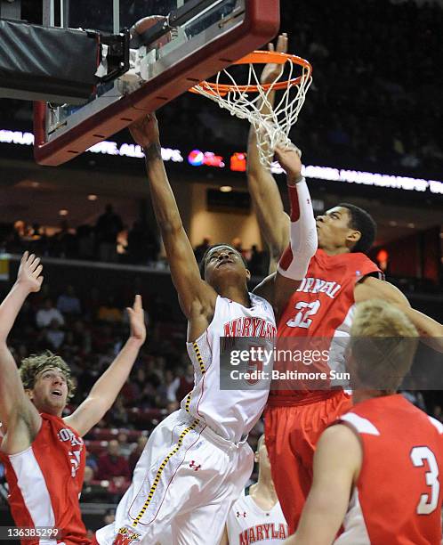 Maryland's Nick Faust is unable to score as Cornell's Shonn Miller defends on the play during 2nd-half action at the Comcast Center in College Park,...