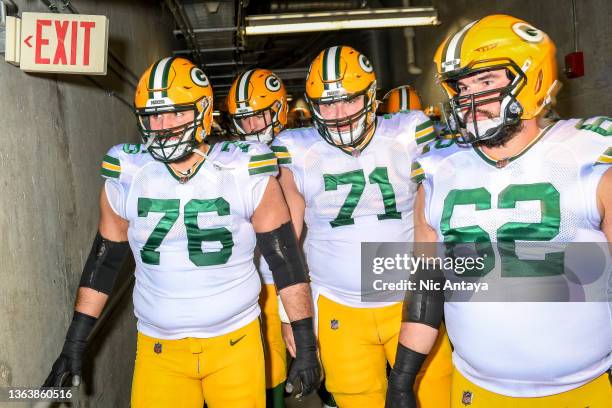 Jon Runyan, Josh Myers and Lucas Patrick of the Green Bay Packers walk through the tunnel to the field before the game against the Detroit Lionsat...