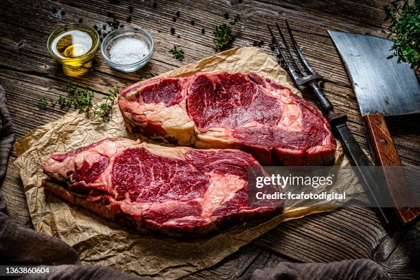 two raw juicy beef steak fillets on rustic table - butcher paper stock pictures, royalty-free photos & images