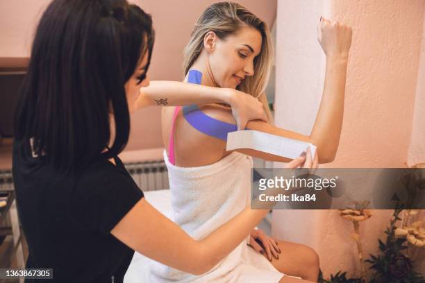 beautiful young woman paying a visit to a beauty shop - kinesiotape stock pictures, royalty-free photos & images