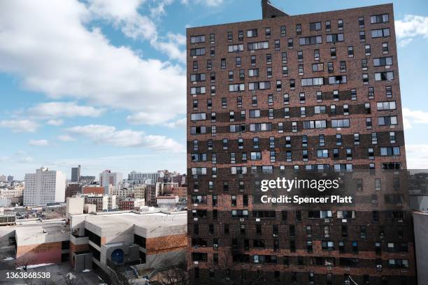 The Bronx apartment building stands a day after a fire swept through the complex killing at least 17 people and injuring dozens of others, many of...