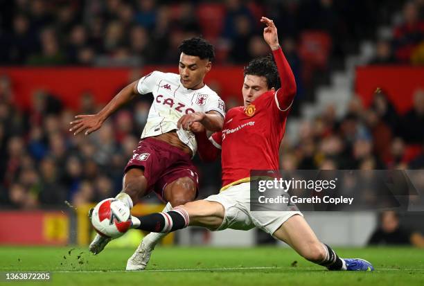 Ollie Watkins of Aston Villa shoots under pressure from Victor Lindelof of Manchester United during the Emirates FA Cup Third Round match between...