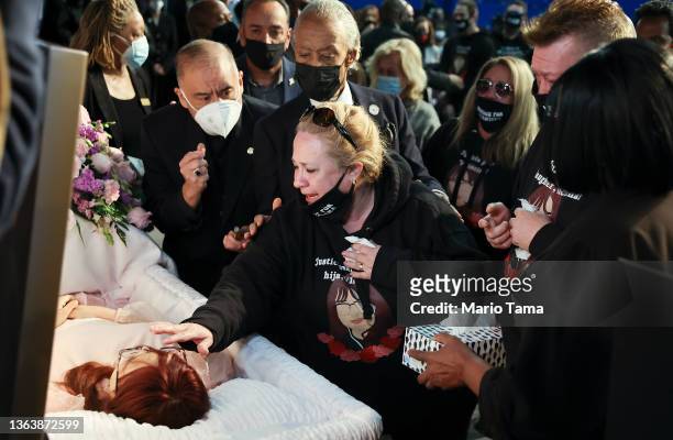 Soledad Peralta reaches to touch her daughter, Valentina Orellana-Peralta during her funeral as Civil rights leader Al Sharpton stands behind at...