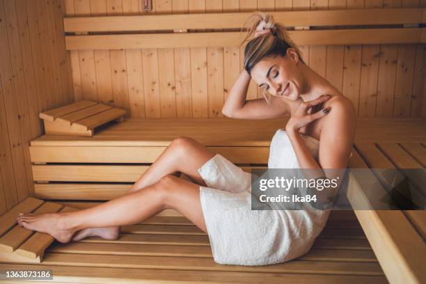 beautiful young woman paying a visit to a spa - sauna wellness stock pictures, royalty-free photos & images