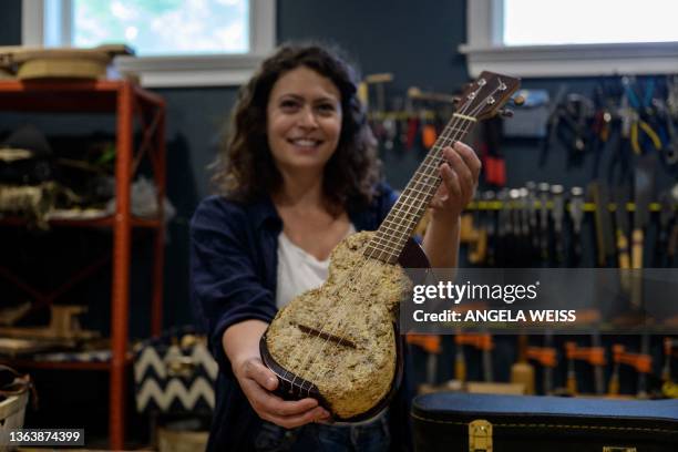 French luthier Rachel Rosenkrantz plays a ukulele made using mycelium in her studio on June 21 in Providence, Rhode Island. Leave mushroom spores in...