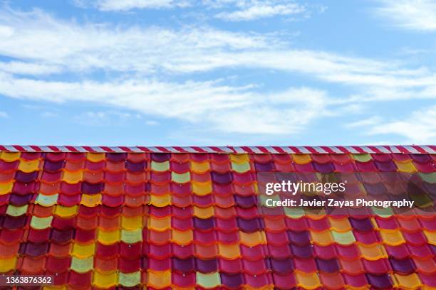 multi colored tiled roof - abundance tiles stock pictures, royalty-free photos & images