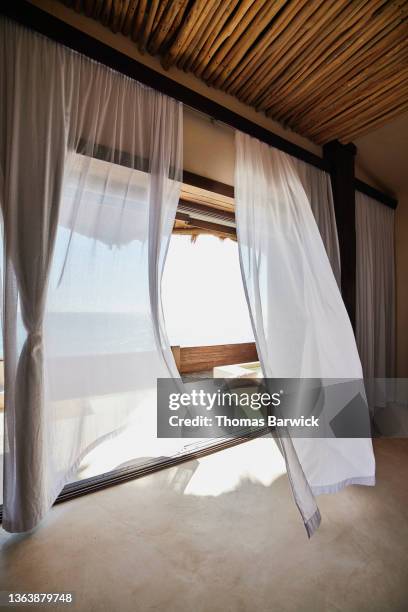 wide shot of curtains blowing in wind in luxury suite at tropical resort - quintana roo stock-fotos und bilder