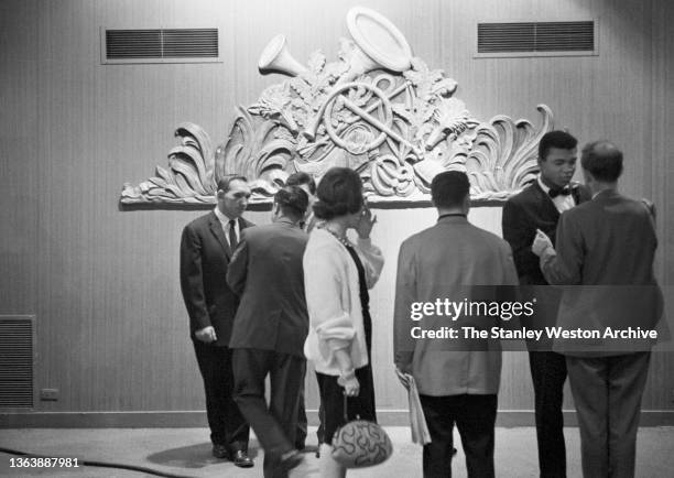 Photo shows Gene Fullmer and Muhammad Ali socializing at the Sheraton Hotel in Chicago while attending the pre-fight weigh-in for the Sonny Liston...