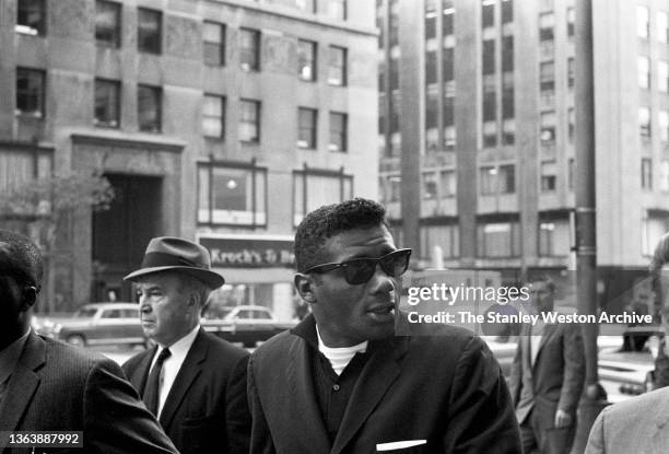 Photo shows Floyd Patterson arriving at the Sheraton Hotel in Chicago where he was in attendance for his pre-fight weigh-in for his bout aginst Sonny...