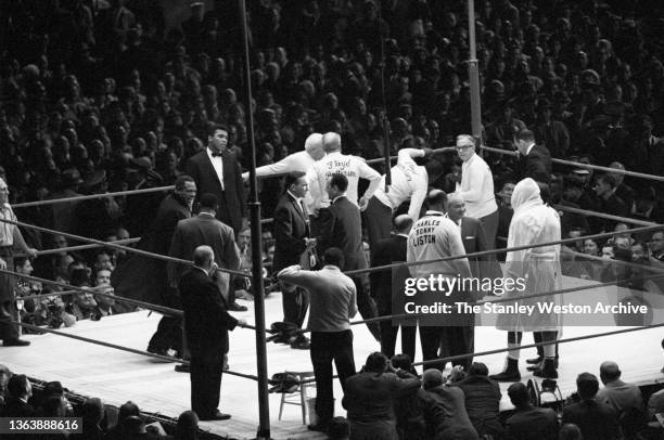 Photo shows Muhammad Ali standing directly across the ring from Sonny Liston who is about to fight Floyd Patterson for the heavyweight Title....
