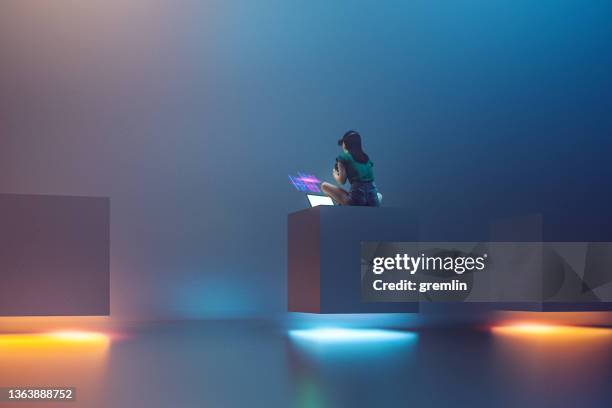 young woman using laptop for vr experience - futuristic stock pictures, royalty-free photos & images