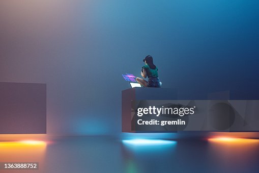 Young woman using laptop for VR experience Young woman using laptop for VR experience