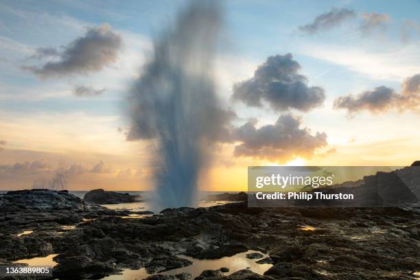 slow shutter of geyser hole shooting into sky at sunset - slow shutter stock pictures, royalty-free photos & images