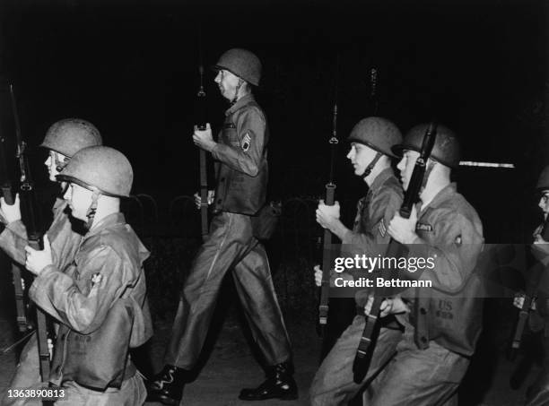 National Guard soldiers with fixed bayonets on their rifles move down a street as Alabama's Governor Patterson proclaimed martial law to prevent...