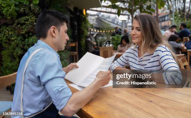 waiter reading the menu to the restaurant owner - bar reopening stock pictures, royalty-free photos & images
