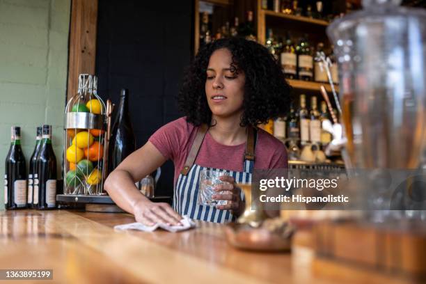 bartender cleaning the counter bar while working at a restaurant - bar reopening stock pictures, royalty-free photos & images