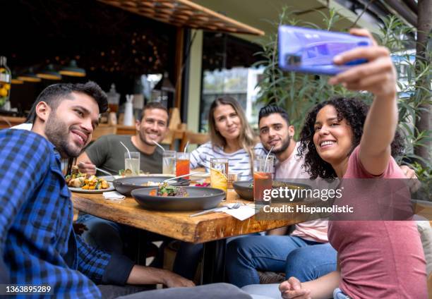 happy group of friends talking a selfie at a restaurant - bar reopening stock pictures, royalty-free photos & images