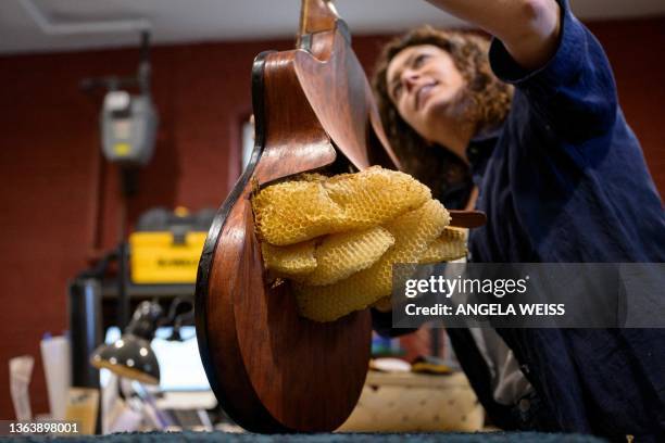 French luthier Rachel Rosenkrantz holds her "Pawtuxet", a guitar made using honeycomb in her studio on June 21 in Providence, Rhode Island. Leave...