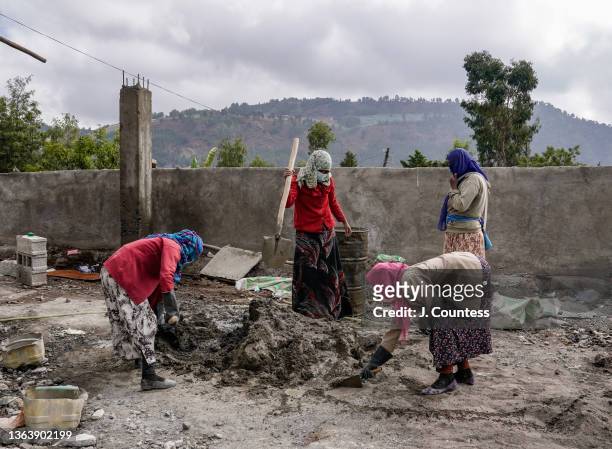 Construction workers mix cement during reconstruction at the Dessie Referral Hospital on January 10, 2022 in Dessie, Ethiopia. The Dessie Referral...