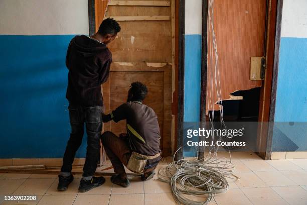 Construction workers replace door frames during reconstruction at the Dessie Referral Hospital on January 10, 2022 in Dessie, Ethiopia. The Dessie...
