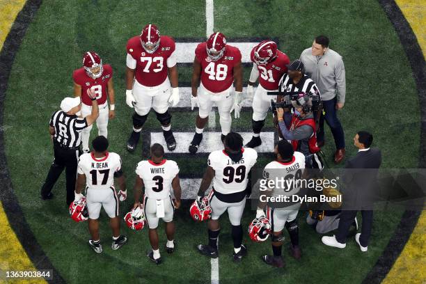 Georgia Bulldogs captains and Alabama Crimson Tide players gather at the center of the field for the coin toss before the 2022 CFP National...