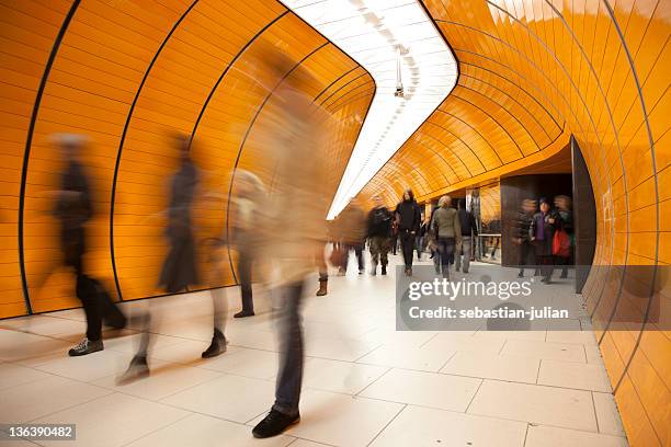 people passing by on modern orange subway - abstract architecture and people stock pictures, royalty-free photos & images