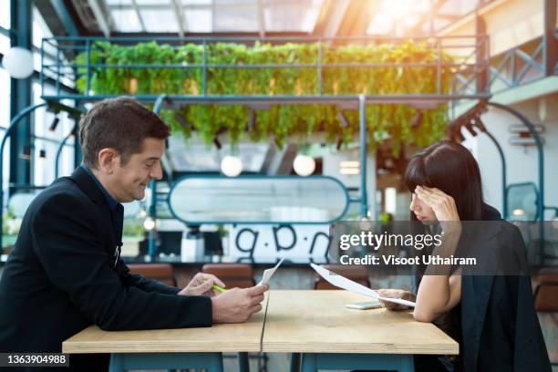 stressed woman applicant feeling nervous at job interview while hr reading resume. - social contract stockfoto's en -beelden