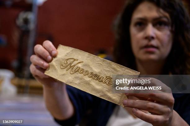 French luthier Rachel Rosenkrantz holds a sample made of mycelium in her studio on June 21 in Providence, Rhode Island. Leave mushroom spores in a...