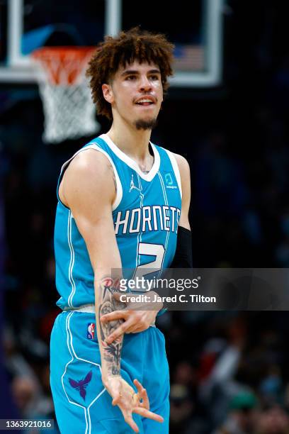 LaMelo Ball of the Charlotte Hornets reacts following a three point basket during the second half of the game against the Milwaukee Bucks at Spectrum...