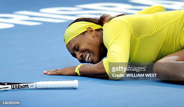 Serena Williams of the US cries out after injuring her ankle during her second round women's singles match against Bojana Jovanovski of Serbia at the...
